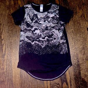 Ivivva black t shirt with silver design on the front.